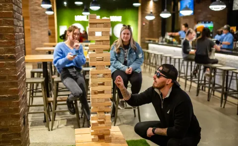 Peeople play Giant Jenga at Pins Nashville.